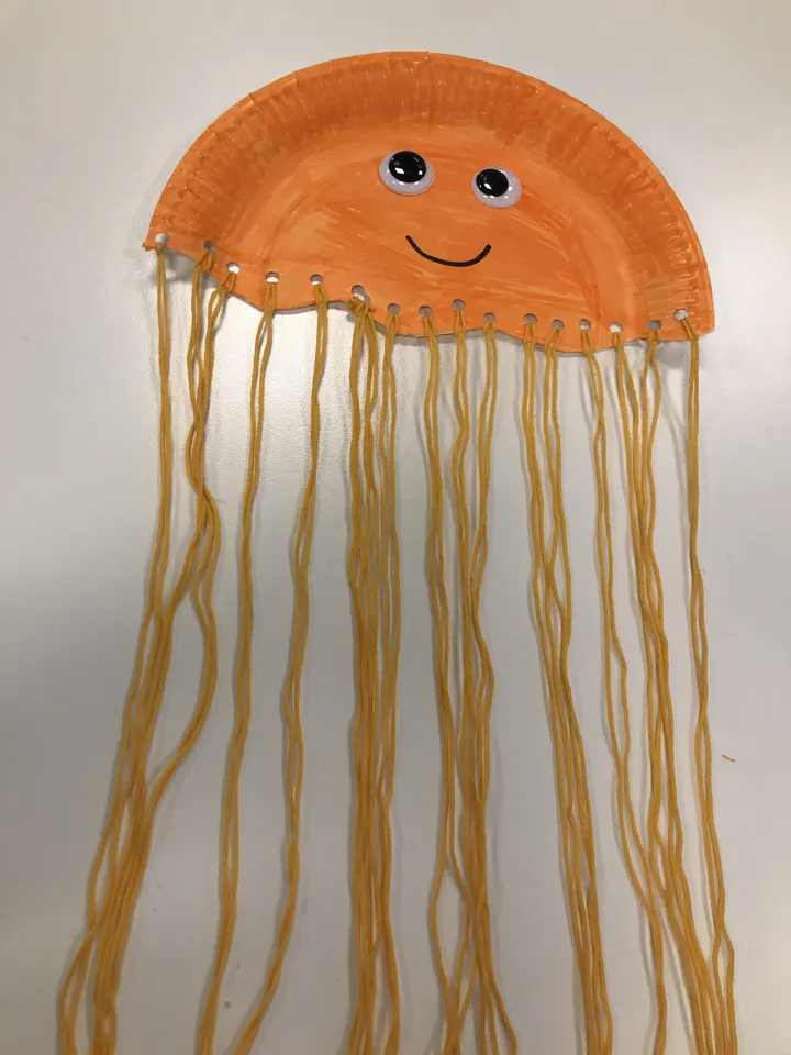 en oransje manet laget av papptallerken og garn. Foto